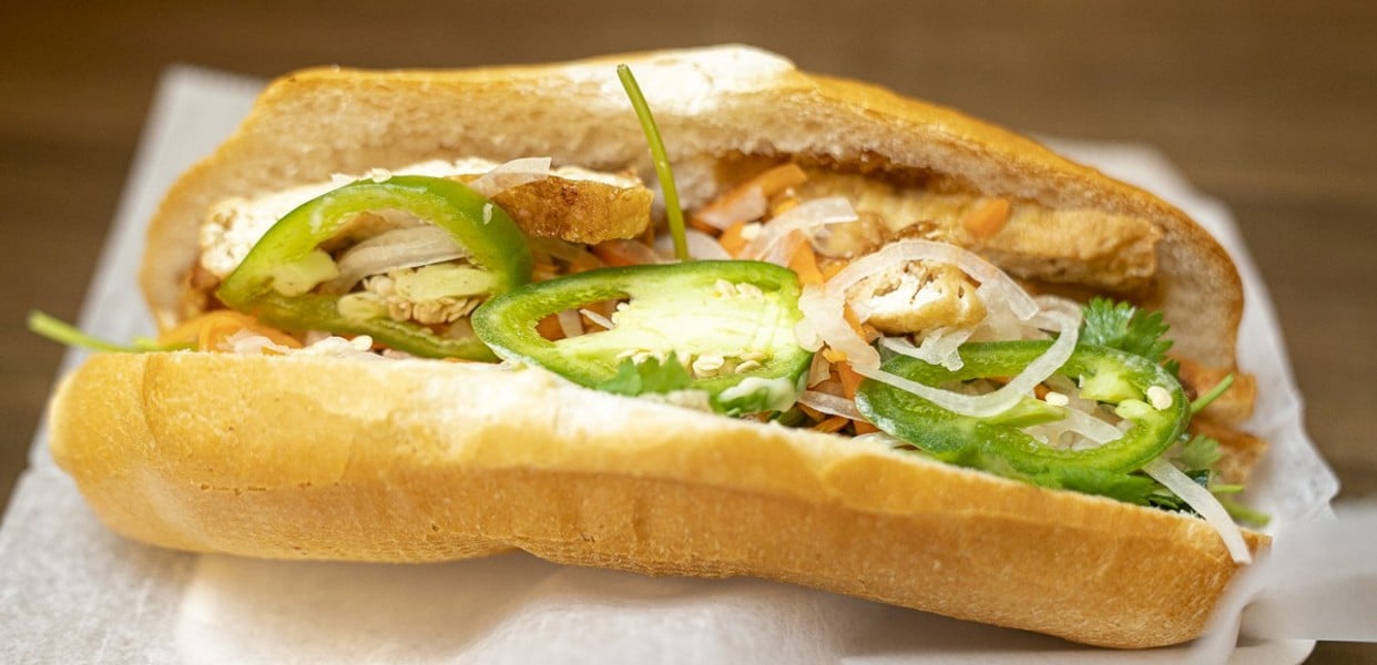 A vegetarian delight packed with tofu, seitan, or mushroom pâté, accompanied by pickled vegetables and fresh herbs